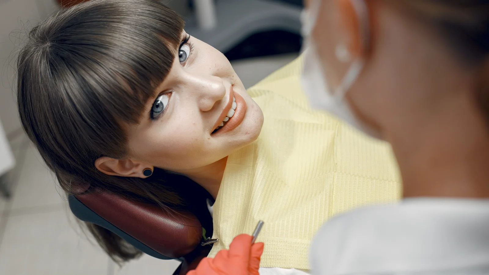 Woman smiling comfortably during a dental visit.