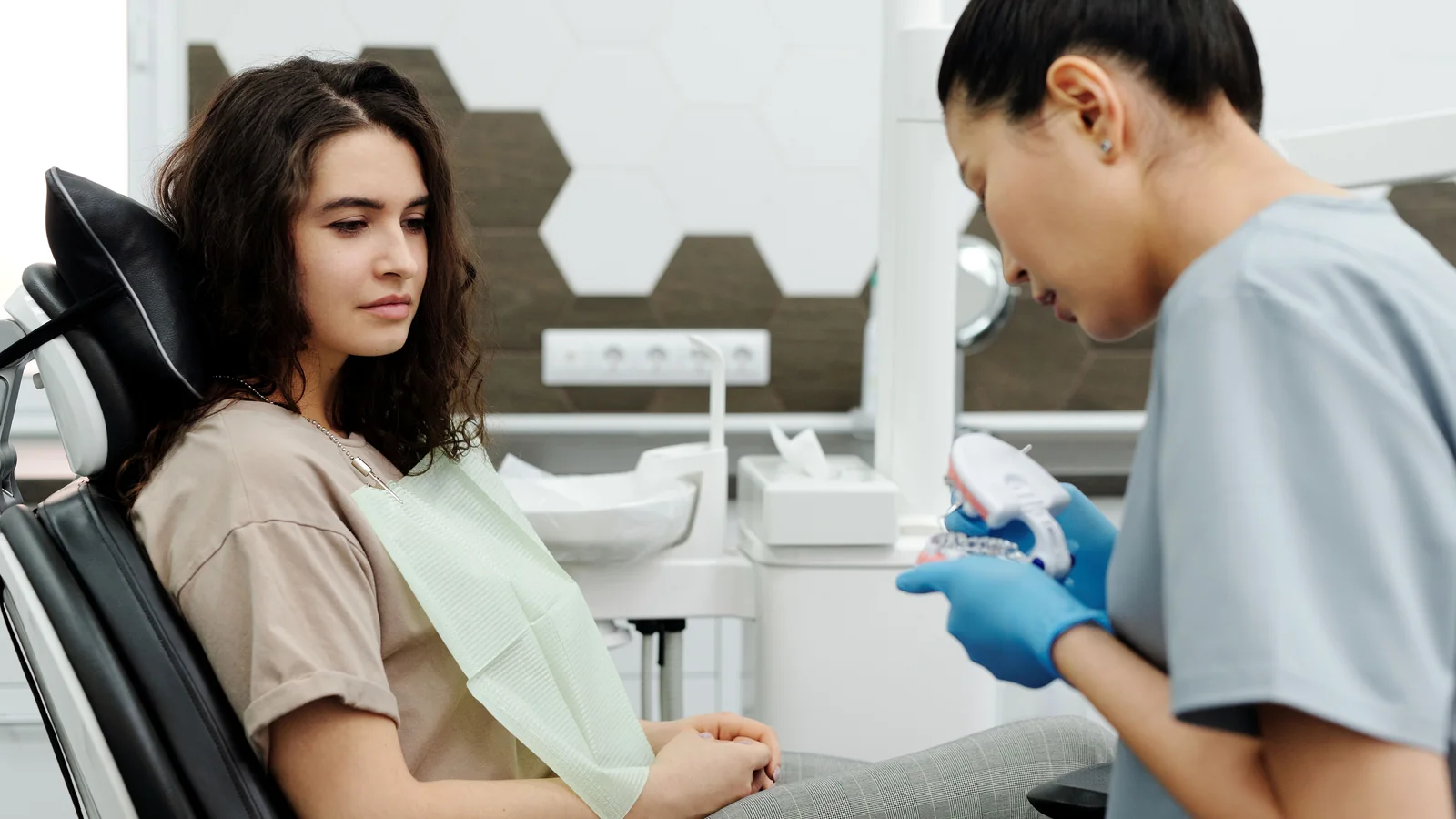 Dentist discussing oral care during a general dental visit.