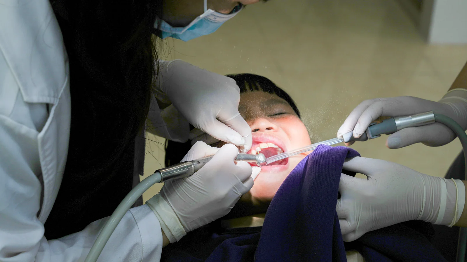 Child receiving dental care in a clinical setting.