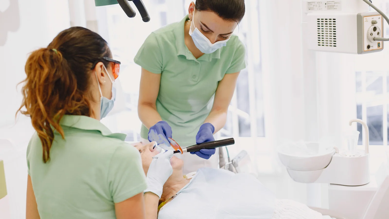 Dental professionals providing restorative treatment.